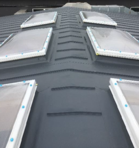 Metal roofing with rooflights on a school roof